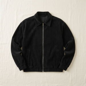 Men's corduroy zip jacket in black, flat-lay with point collar and metal zip