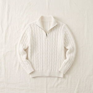 Men's cable-knit quarter-zip sweater in white, flat-lay with half-zip collar