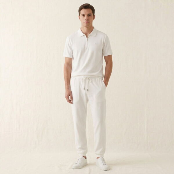 Man wearing a white linen-Tencel polo and jogger set with white sneakers